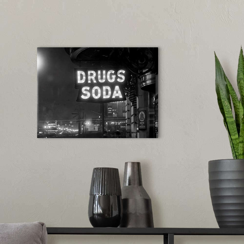 A modern room featuring The sign above the Firemen's Drug Store that indicates Drugs and Soda is illuminated by 110-5 wat...