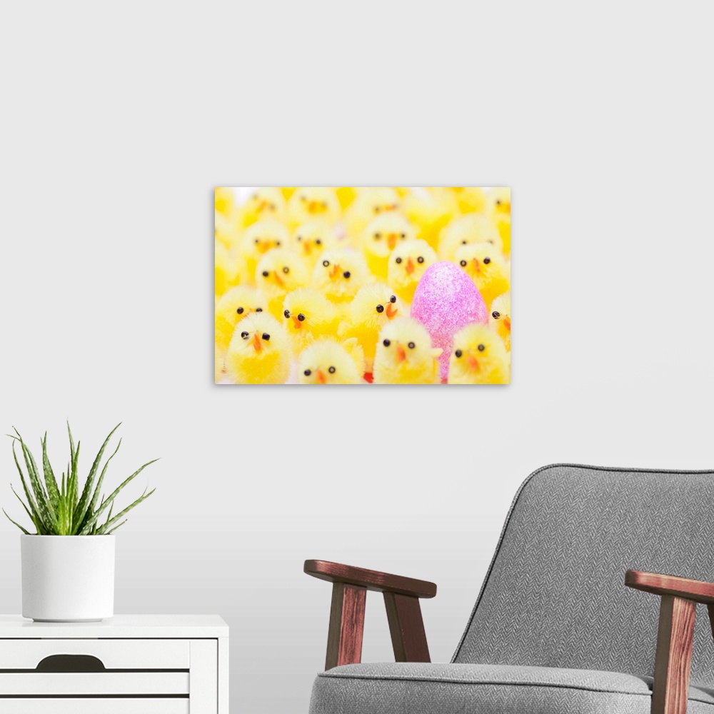 A modern room featuring An Easter egg in a crowd of yellow chicks