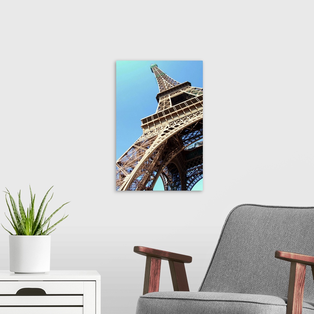 A modern room featuring Eiffel Tower at day light shot from beneath, Paris, France.