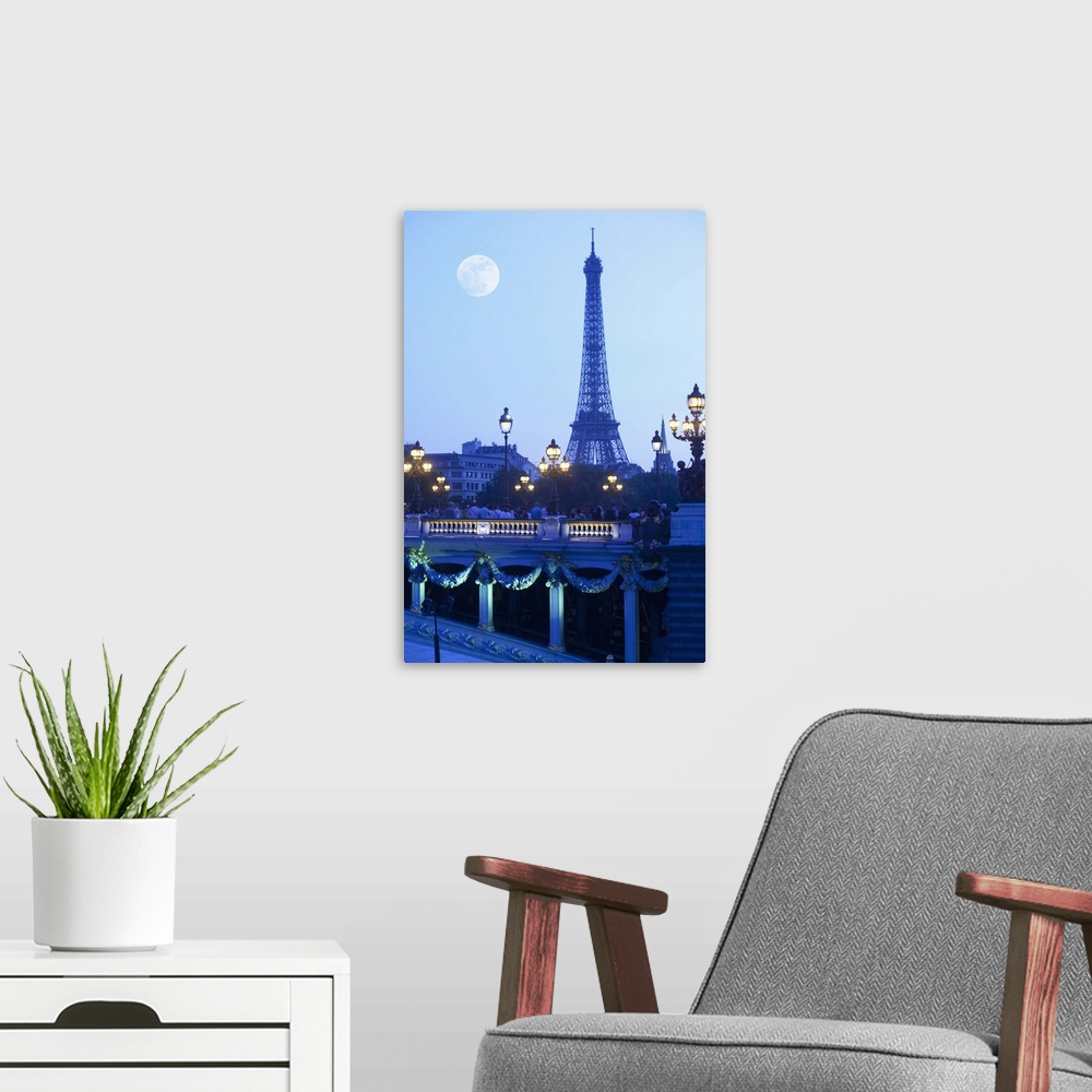 A modern room featuring Eiffel tower at dusk with moonrise