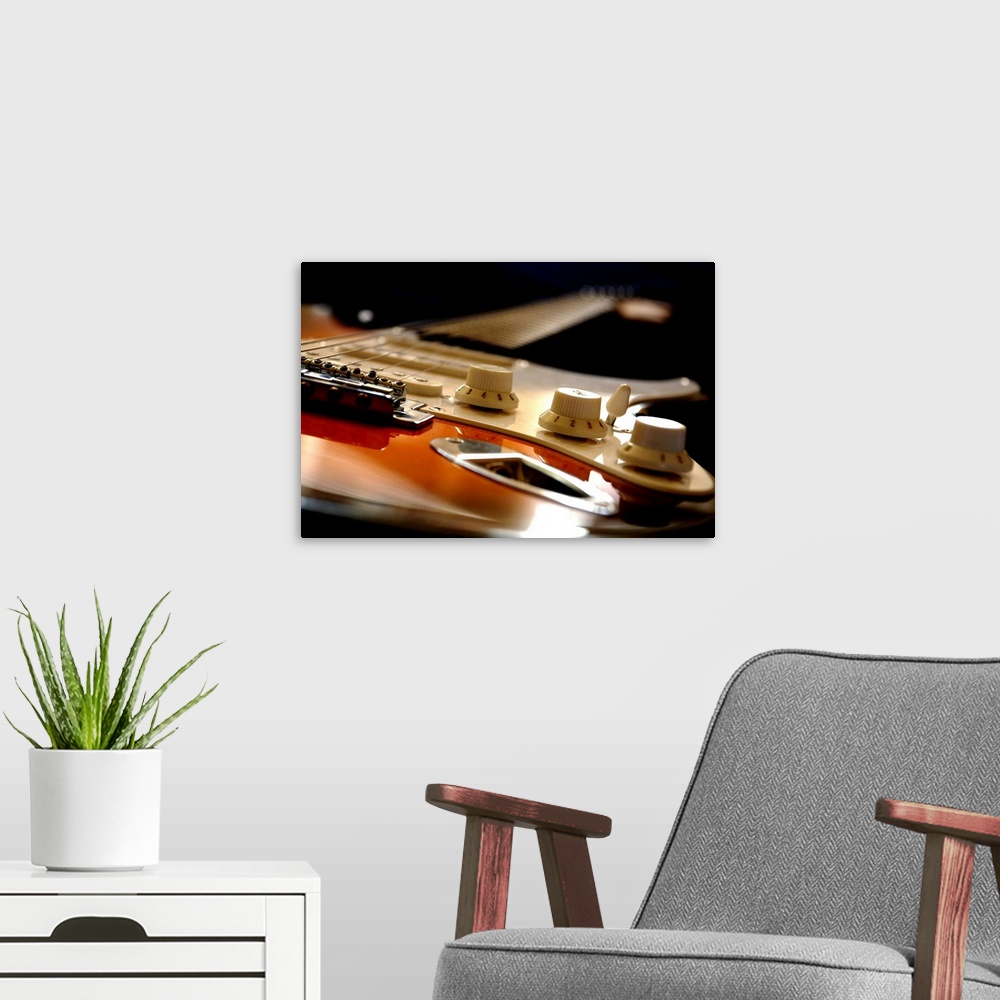 A modern room featuring Up close view of an electric guitar seen from the bottom up on canvas.