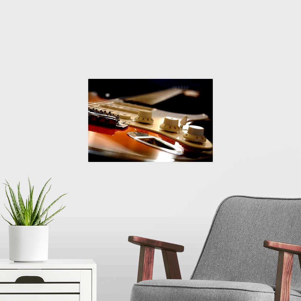 A modern room featuring Up close view of an electric guitar seen from the bottom up on canvas.