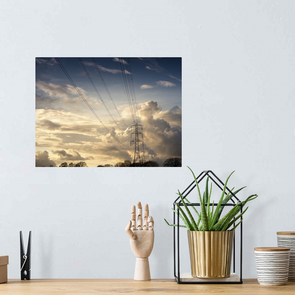 A bohemian room featuring Electric high power lines against beautiful cloud formation.