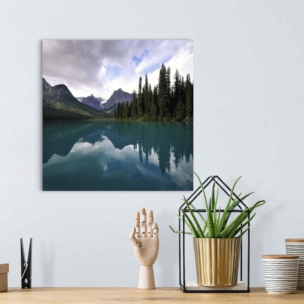 A bohemian room featuring Clouds over mountain and trees with reflection in Emerald lake, Alberta Canada.