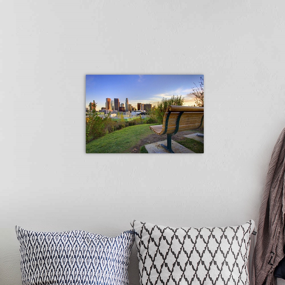 A bohemian room featuring Photograph of park bench overlooking city skyline at dusk.