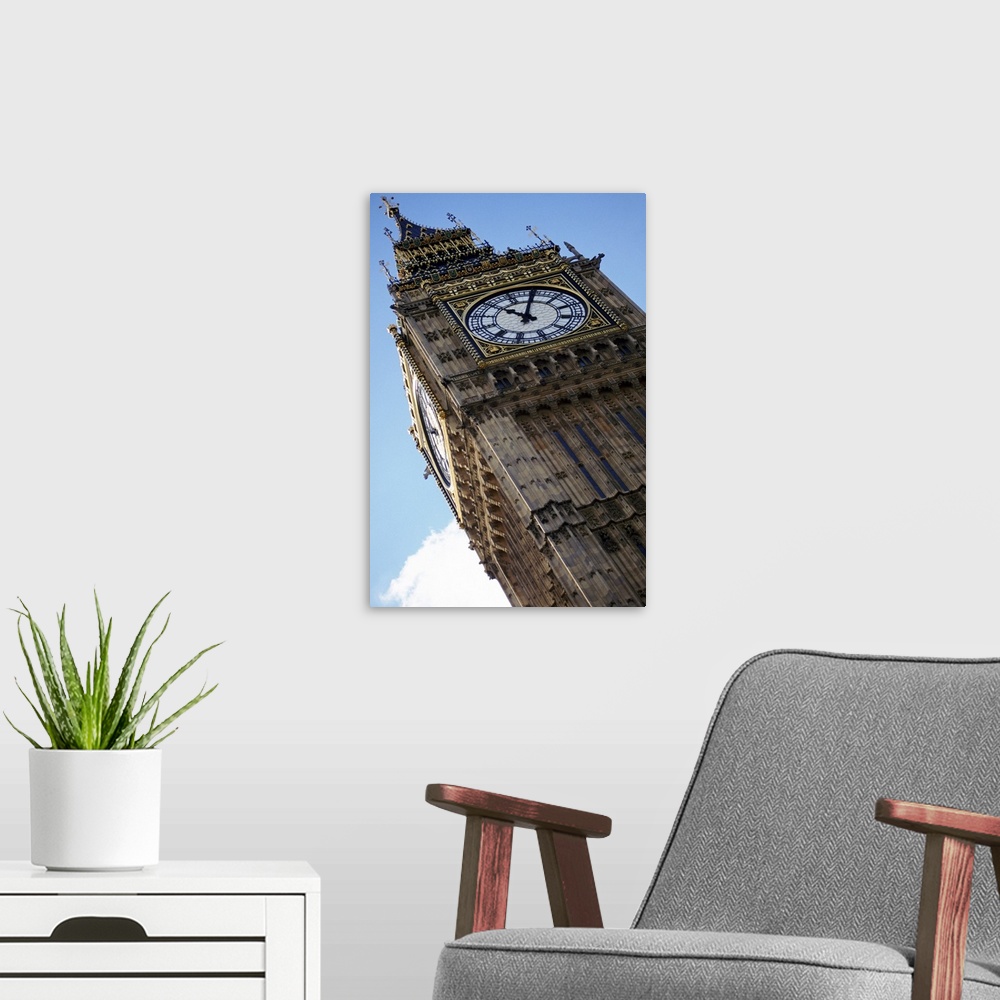 A modern room featuring Big Ben is photographed from below showing mostly the top of the structure at an angle.