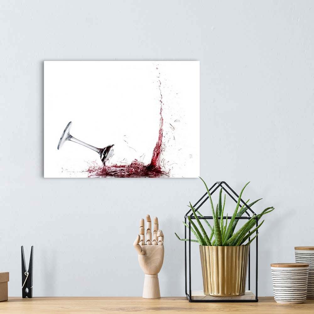 A bohemian room featuring Giant photograph displays a piece of stemware filled with vino as it crashes into the ground and ...