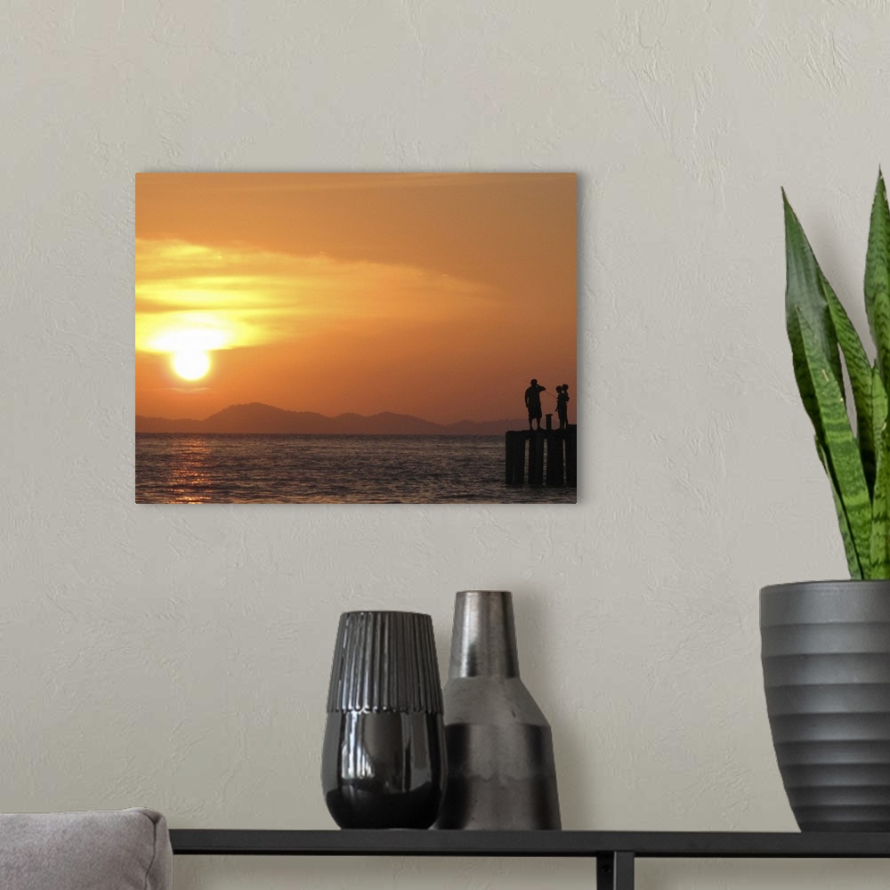 A modern room featuring Family watching sunset from jetty in Malaysia.