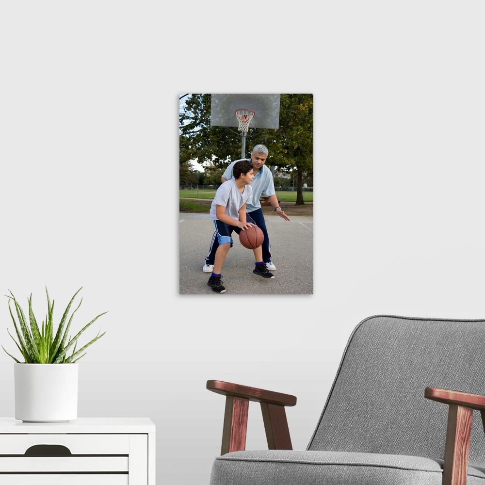 A modern room featuring Hispanic father and son playing basketball