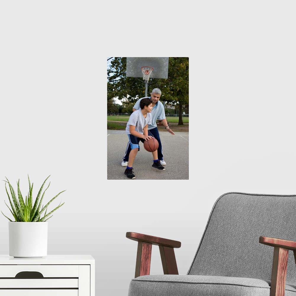 A modern room featuring Hispanic father and son playing basketball