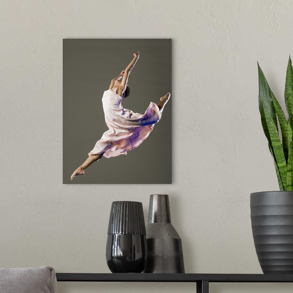 A modern room featuring African female ballet dancer jumping