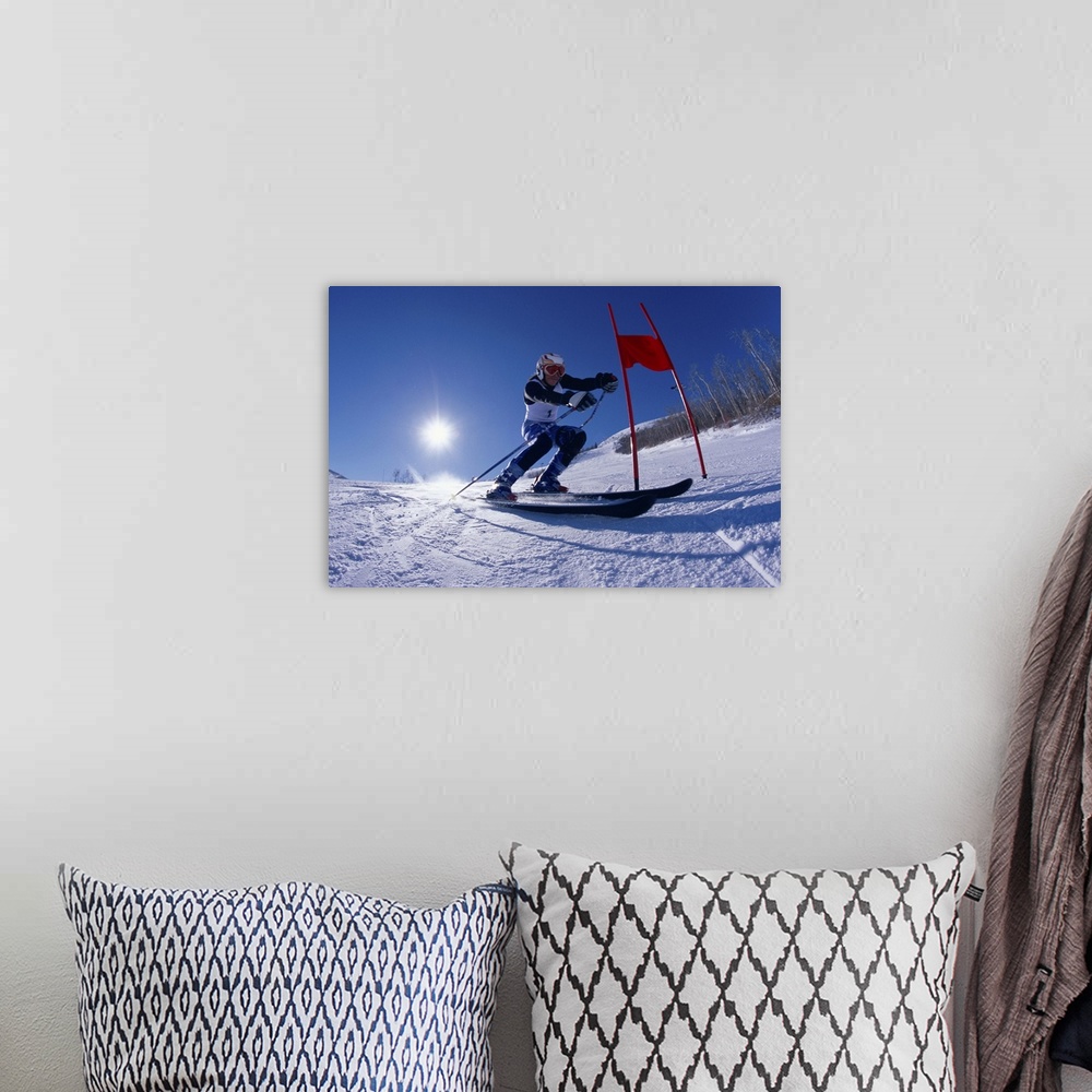 A bohemian room featuring Female skier skiing around red gate, low angle view