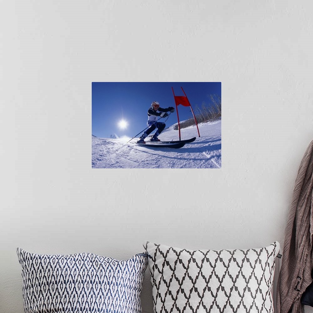A bohemian room featuring Female skier skiing around red gate, low angle view