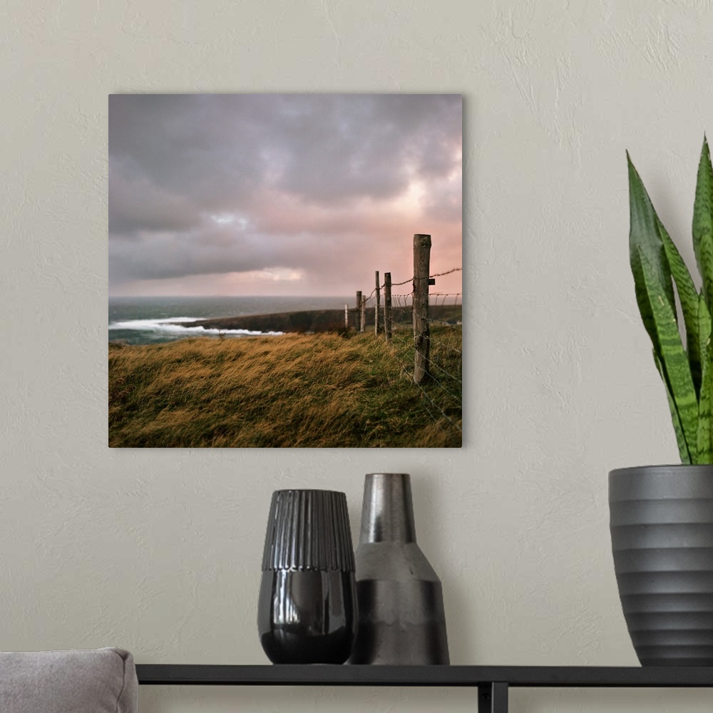 A modern room featuring Fence stretches toward bloody foreland at sunrise in County Donegal, Ireland.