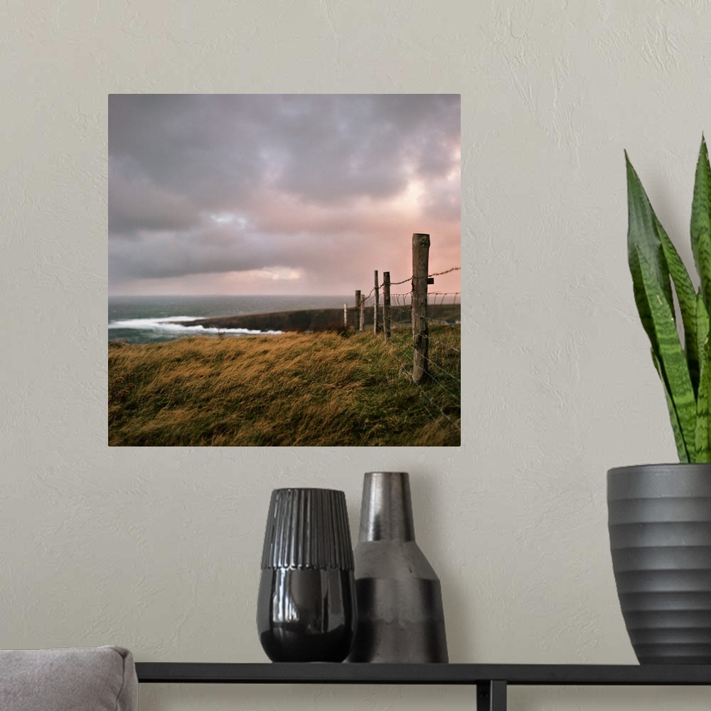 A modern room featuring Fence stretches toward bloody foreland at sunrise in County Donegal, Ireland.
