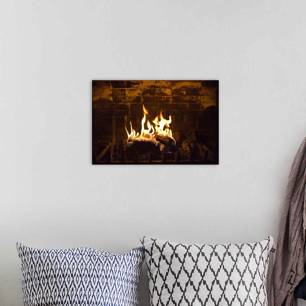A bohemian room featuring Fire in a fireplace