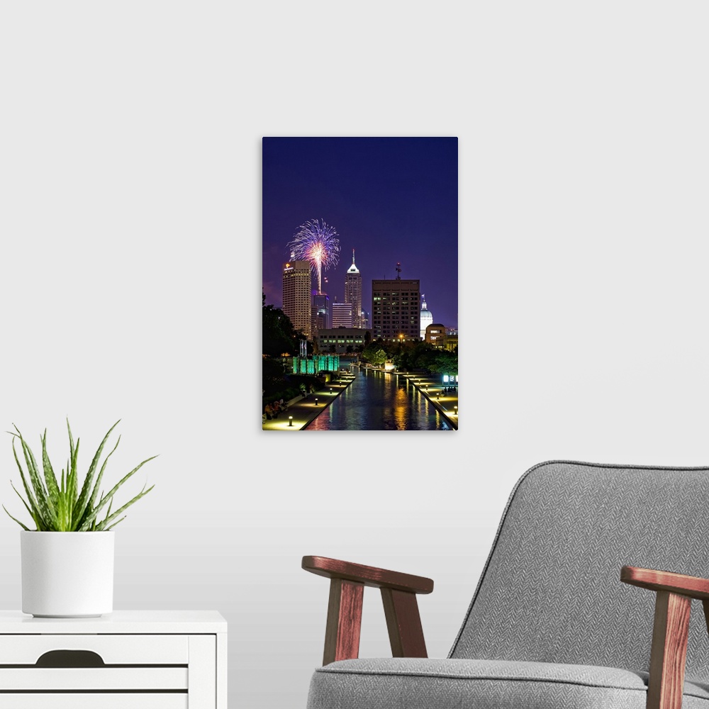 A modern room featuring Downtown Indianapolis with fireworks show in looking down west canal.