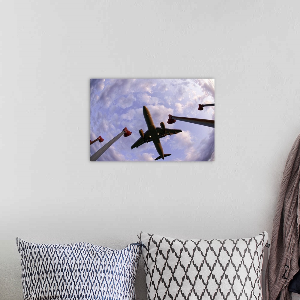 A bohemian room featuring Fisheye wide shot of an airplane landing directly over the viewer