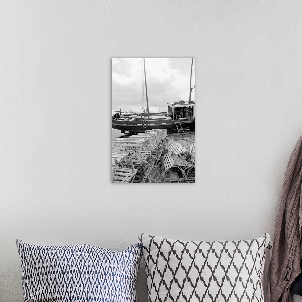 A bohemian room featuring black and white image of fishing vessel and lobster traps