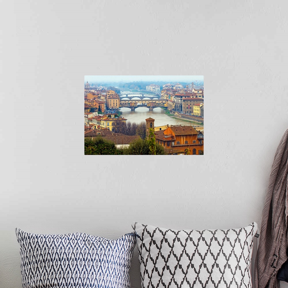A bohemian room featuring Giant photograph overlooking the Fiume Arno surrounded by a busy city within Italy.  On the shore...