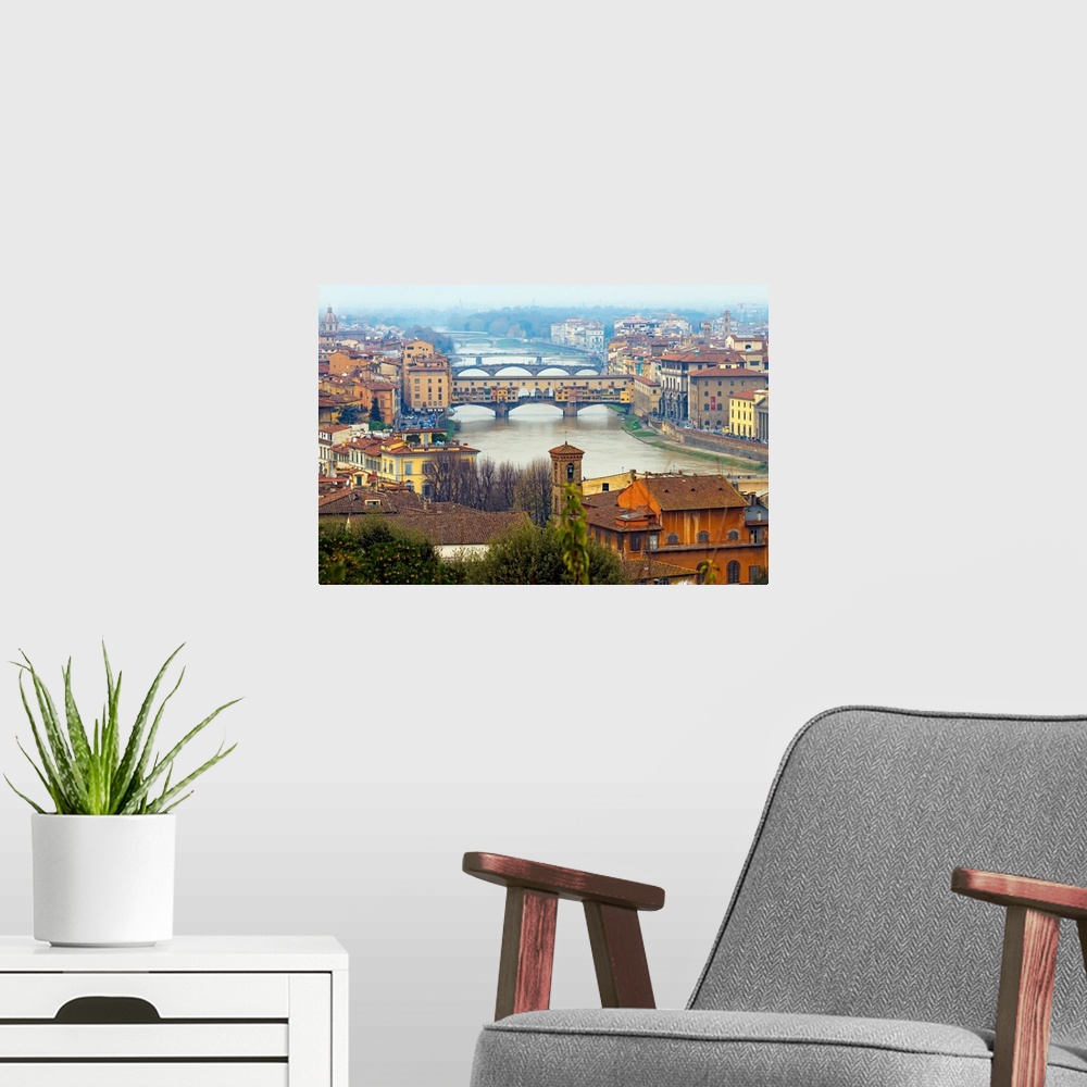 A modern room featuring Giant photograph overlooking the Fiume Arno surrounded by a busy city within Italy.  On the shore...