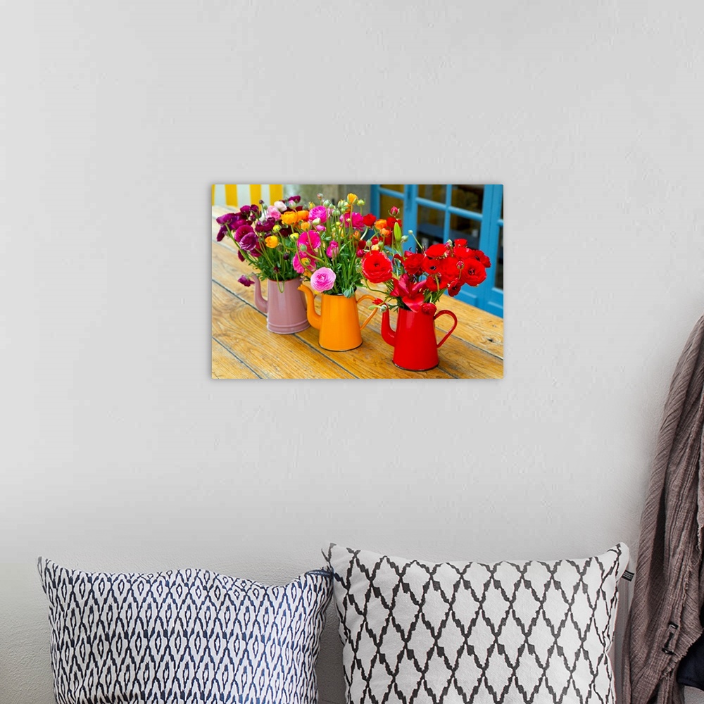 A bohemian room featuring Photograph of three flowerpots sitting on a table with flowers in them.