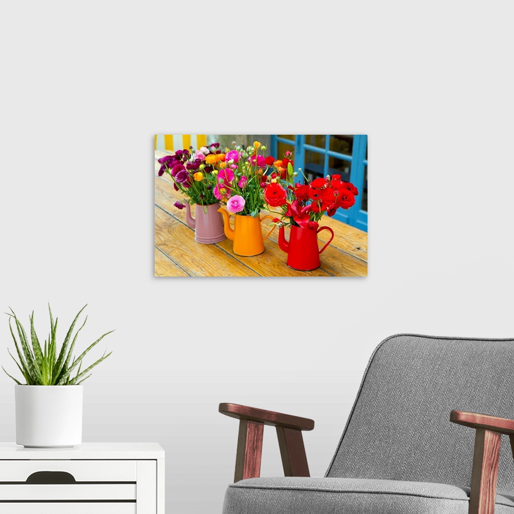 A modern room featuring Photograph of three flowerpots sitting on a table with flowers in them.