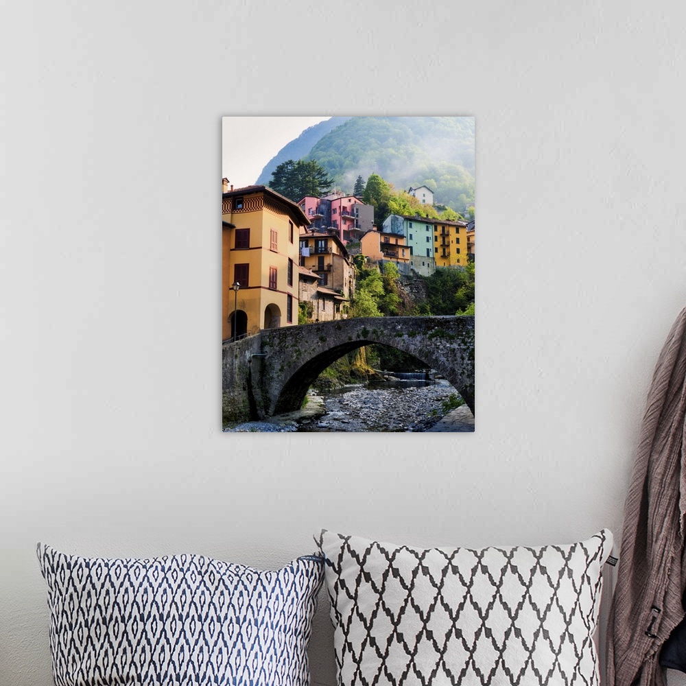 A bohemian room featuring Fog drifts down mountain and through idealistic village along Lake Como.