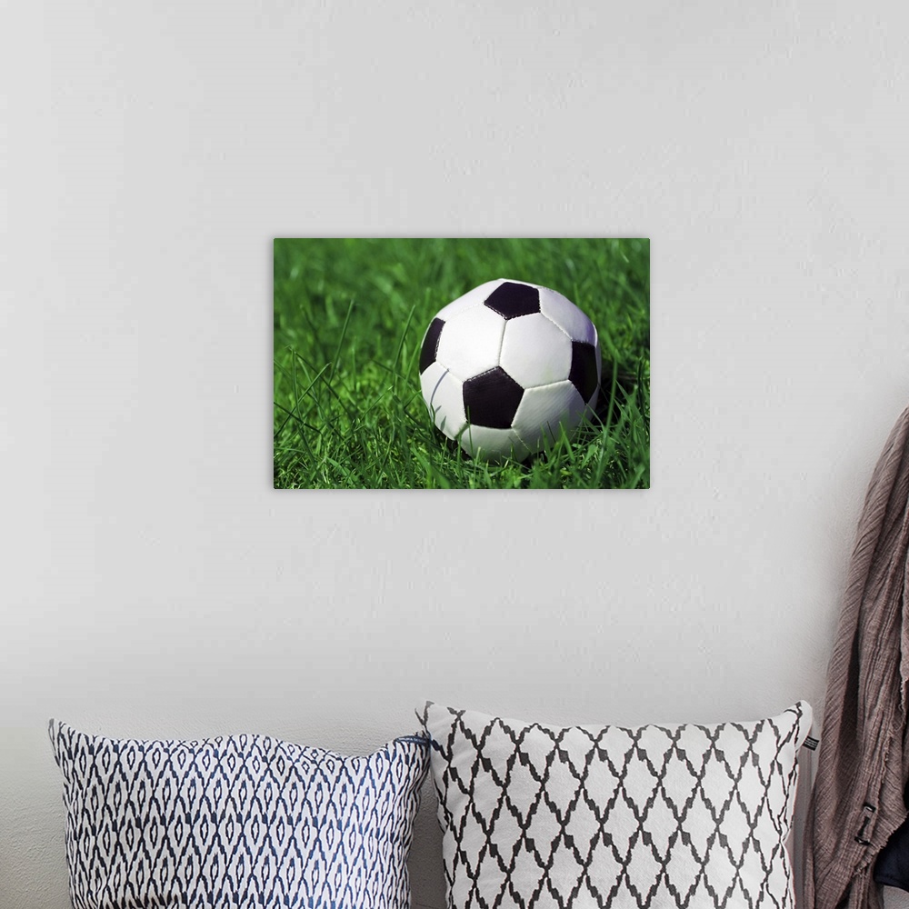A bohemian room featuring Football on a grass field.