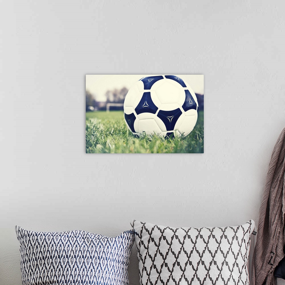 A bohemian room featuring Football on football pitch with goal in distance.