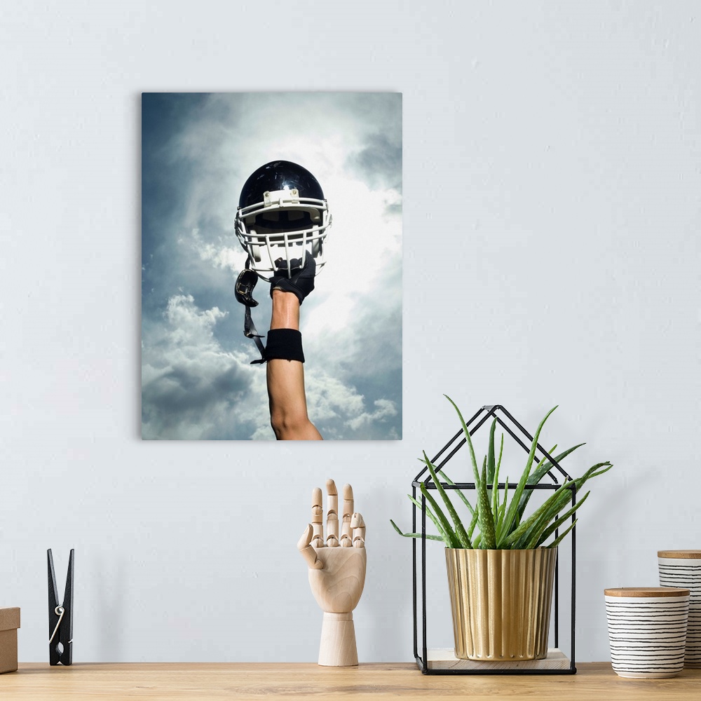 A bohemian room featuring Football player holding helmet in air