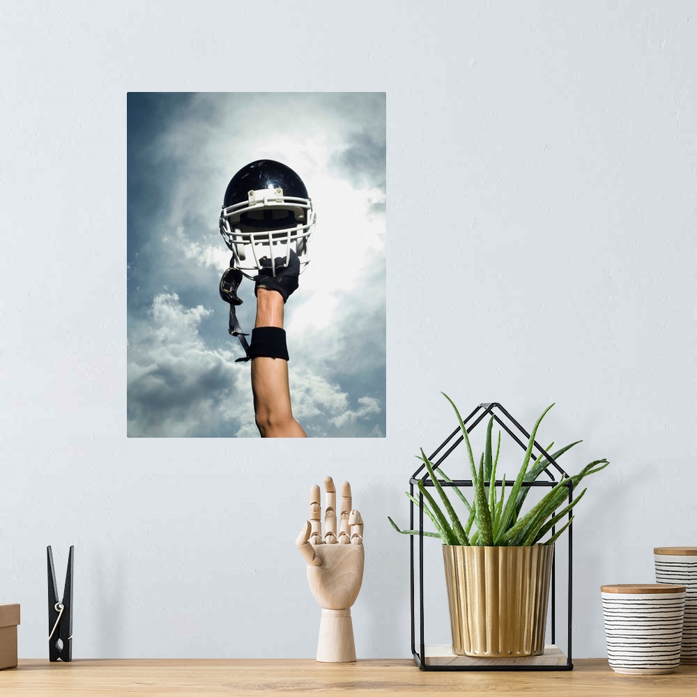 A bohemian room featuring Football player holding helmet in air