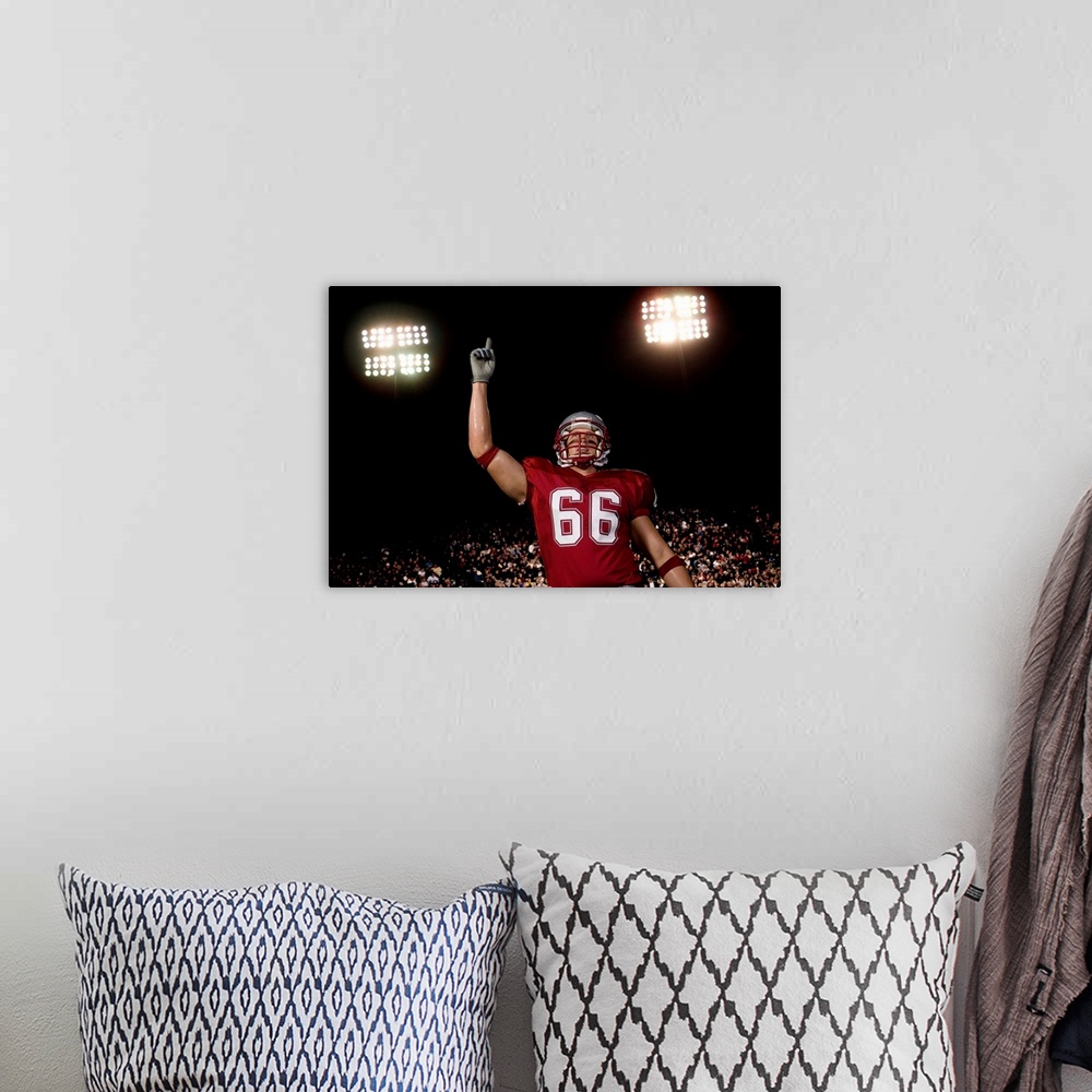 A bohemian room featuring Football player holding up index finger