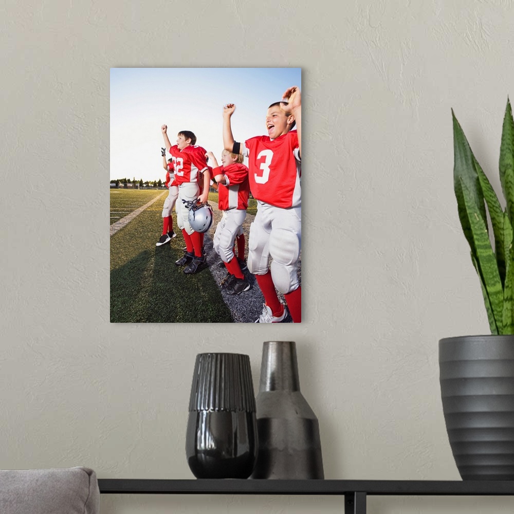 A modern room featuring Football players cheering on sideline
