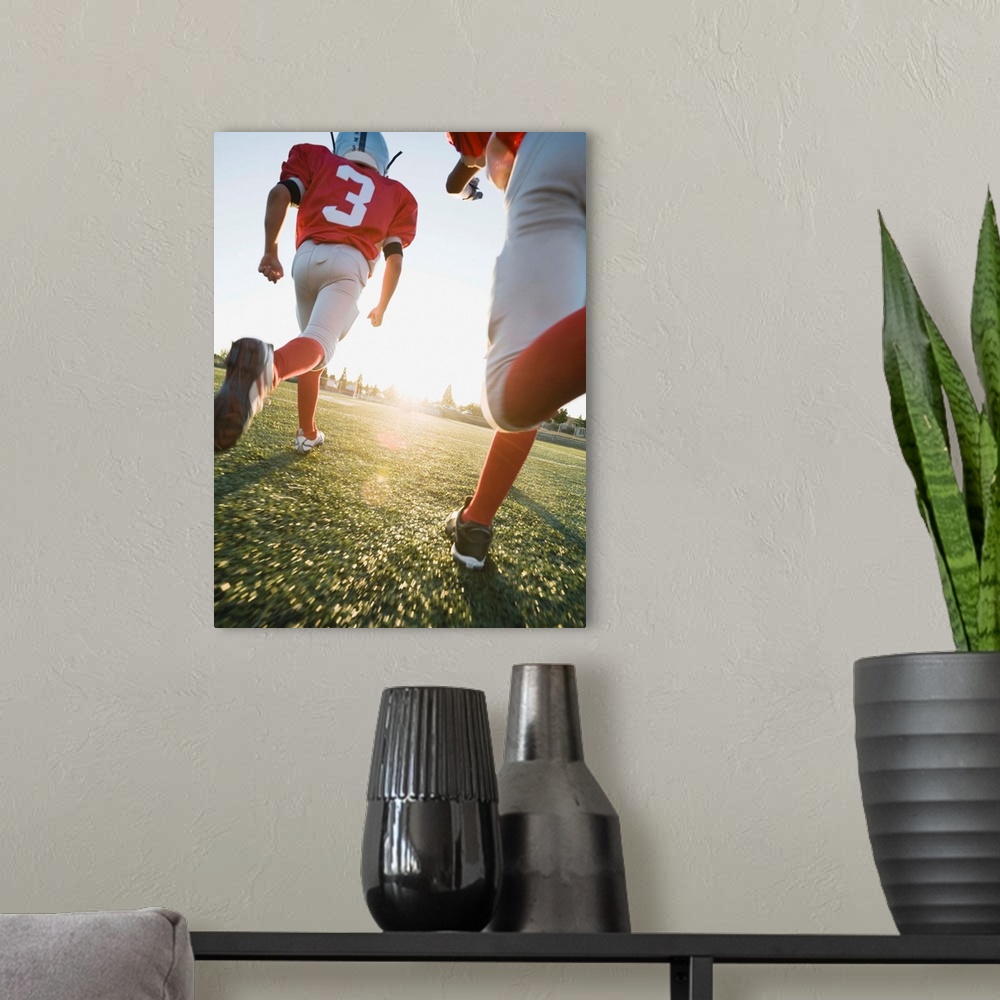 A modern room featuring Football players running on field