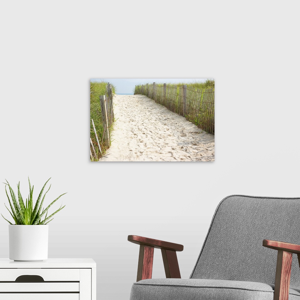 A modern room featuring Footprints in sand of beach access path