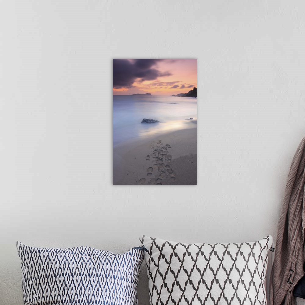A bohemian room featuring Footprints on beach at sunset.
