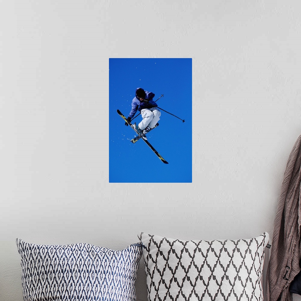 A bohemian room featuring Free skier in mid-air jump, low angle view