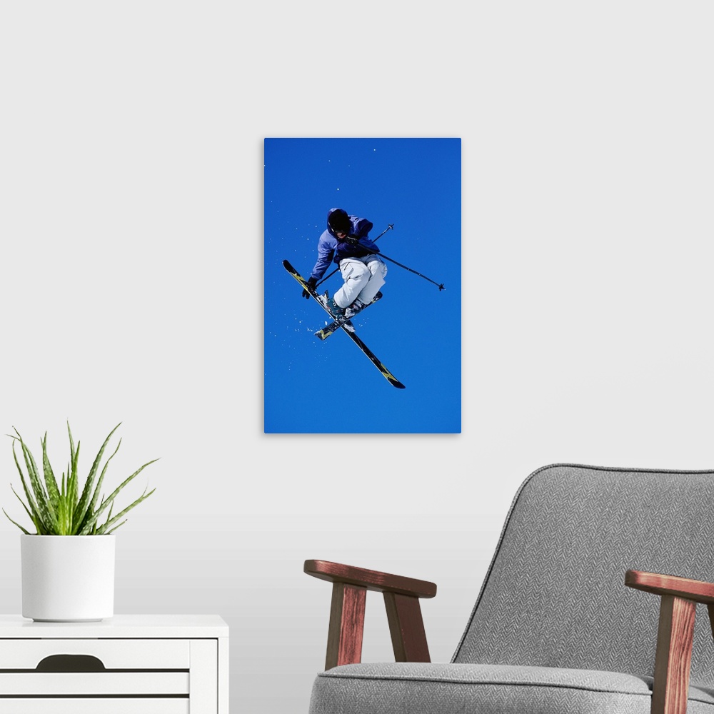 A modern room featuring Free skier in mid-air jump, low angle view