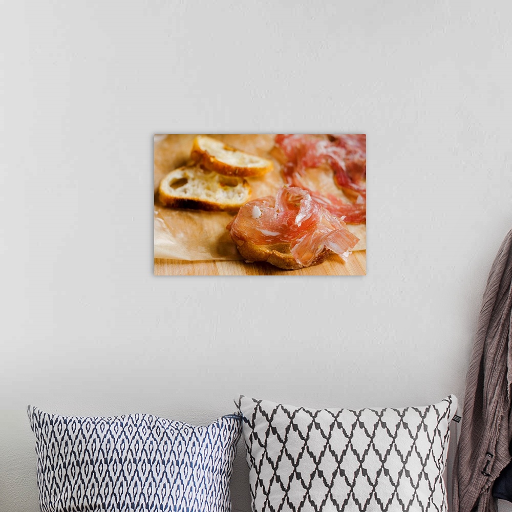 A bohemian room featuring Fresh prosciutto ham with bread