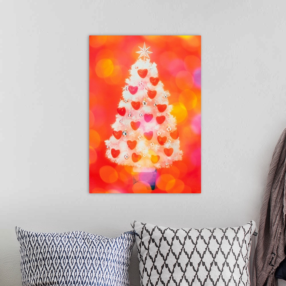 A bohemian room featuring Frosted Christmas tree decorated with heart shaped ornaments, front view, composition