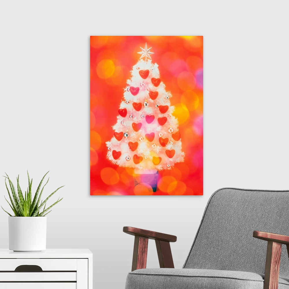 A modern room featuring Frosted Christmas tree decorated with heart shaped ornaments, front view, composition