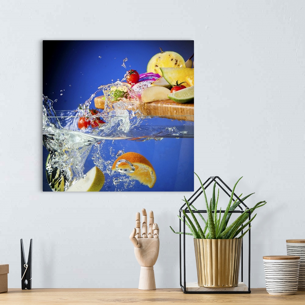 A bohemian room featuring Fresh assorted Fruits on a chopping board splashing in a tank of water