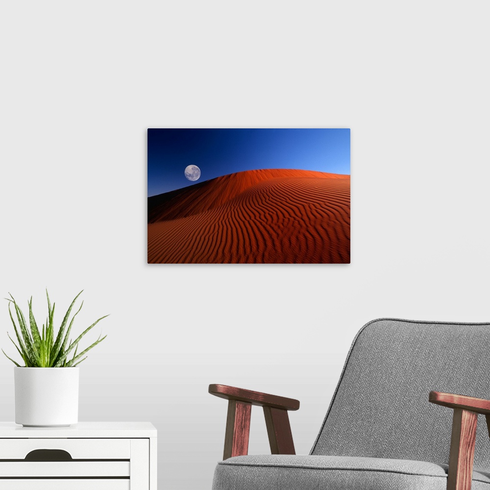 A modern room featuring Full Moon Over Red Dunes