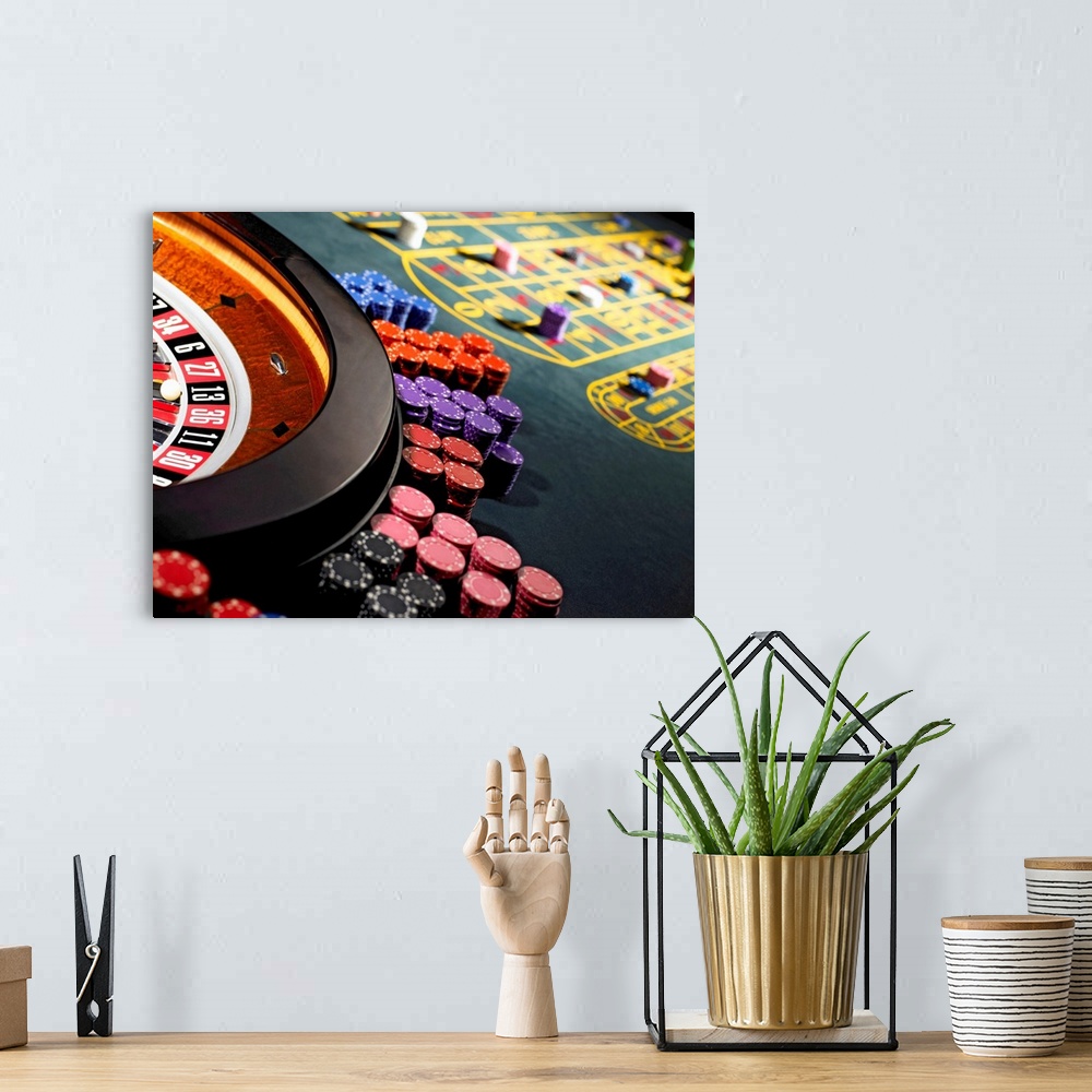 A bohemian room featuring Gambling chips stacked around roulette wheel on gaming table