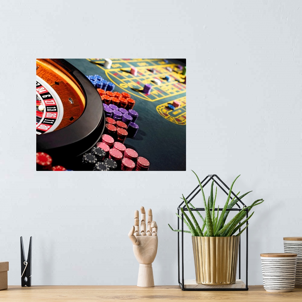 A bohemian room featuring Gambling chips stacked around roulette wheel on gaming table