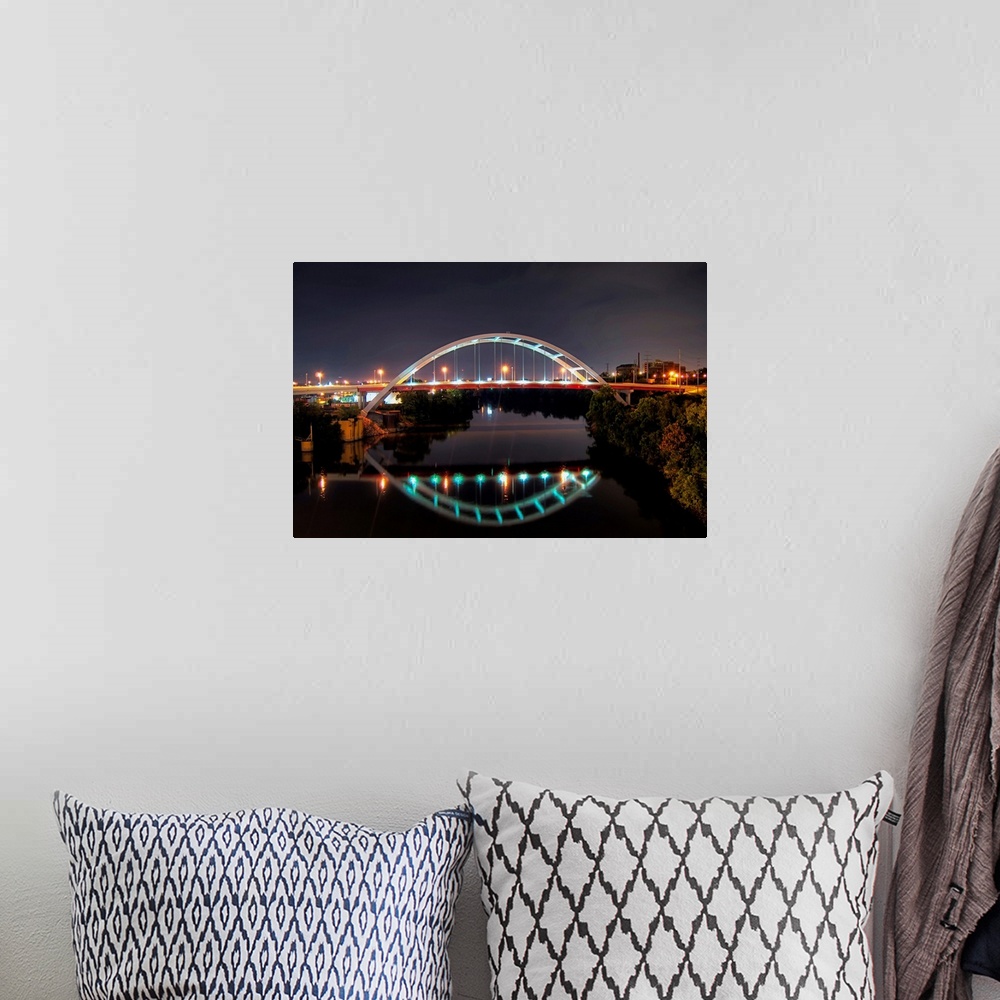 A bohemian room featuring Arch of Gateway bridge over Cumberland river in  Nashville at night.