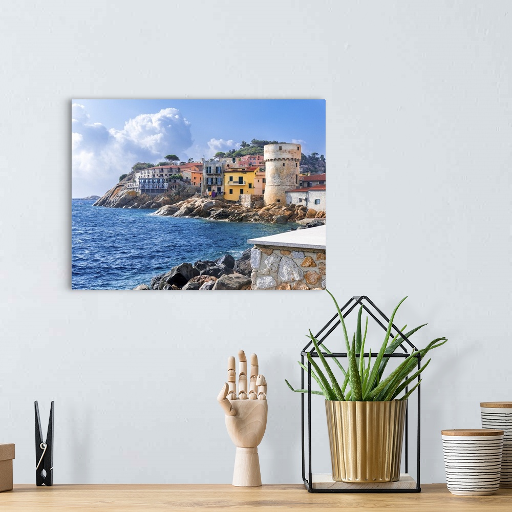 A bohemian room featuring The perfect tiny seaside village of "Giglio Porto" with multi colored houses, an ancient defensiv...