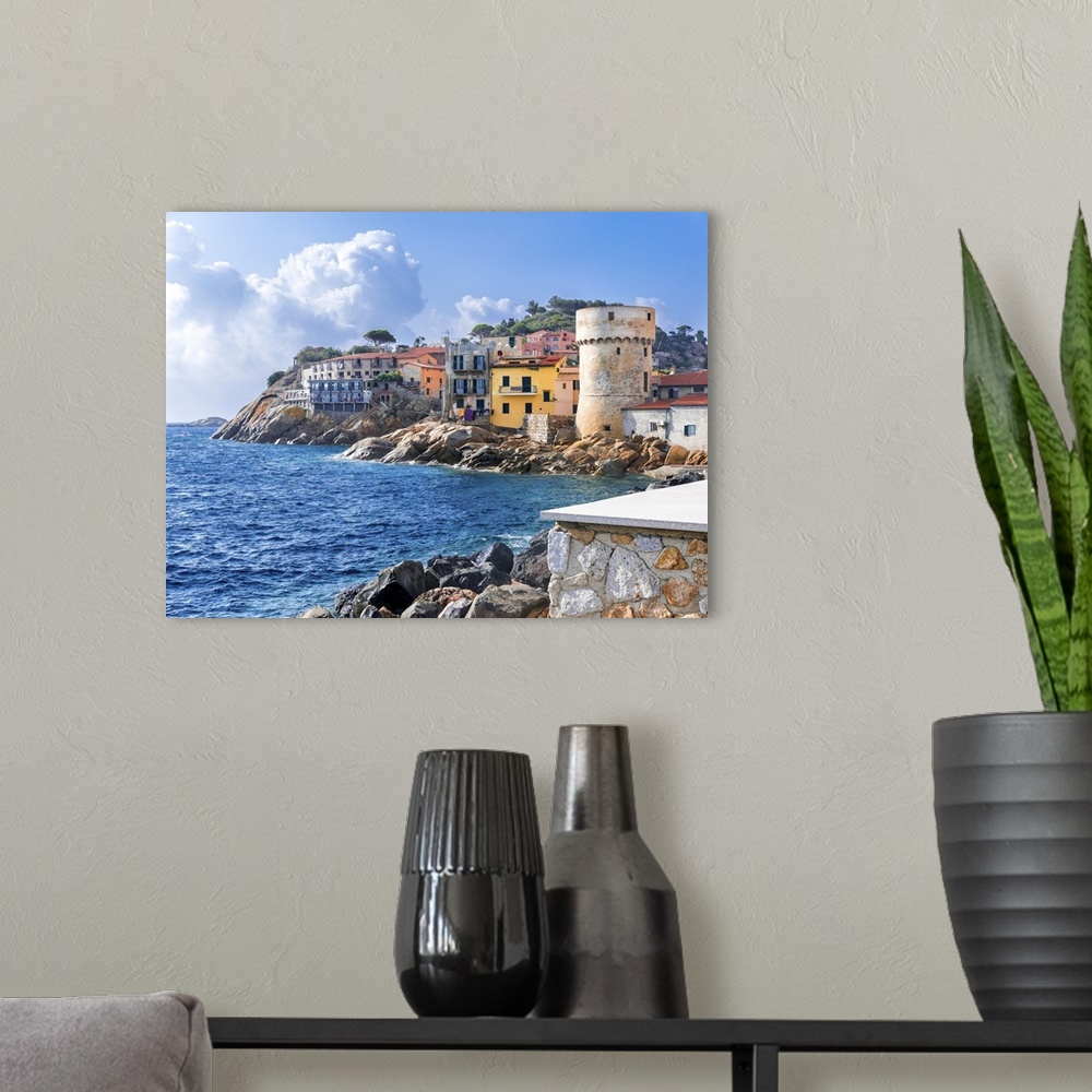 A modern room featuring The perfect tiny seaside village of "Giglio Porto" with multi colored houses, an ancient defensiv...