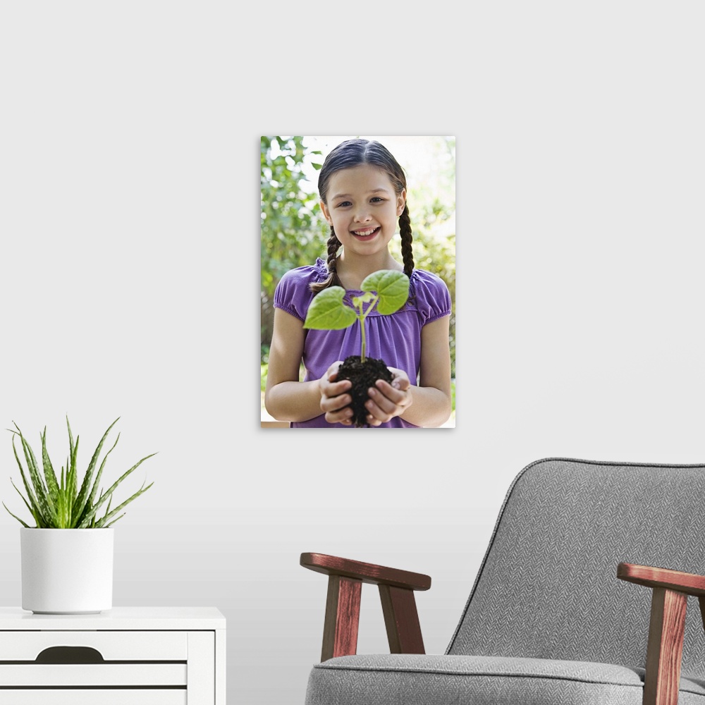 A modern room featuring Girl holding soil and plant